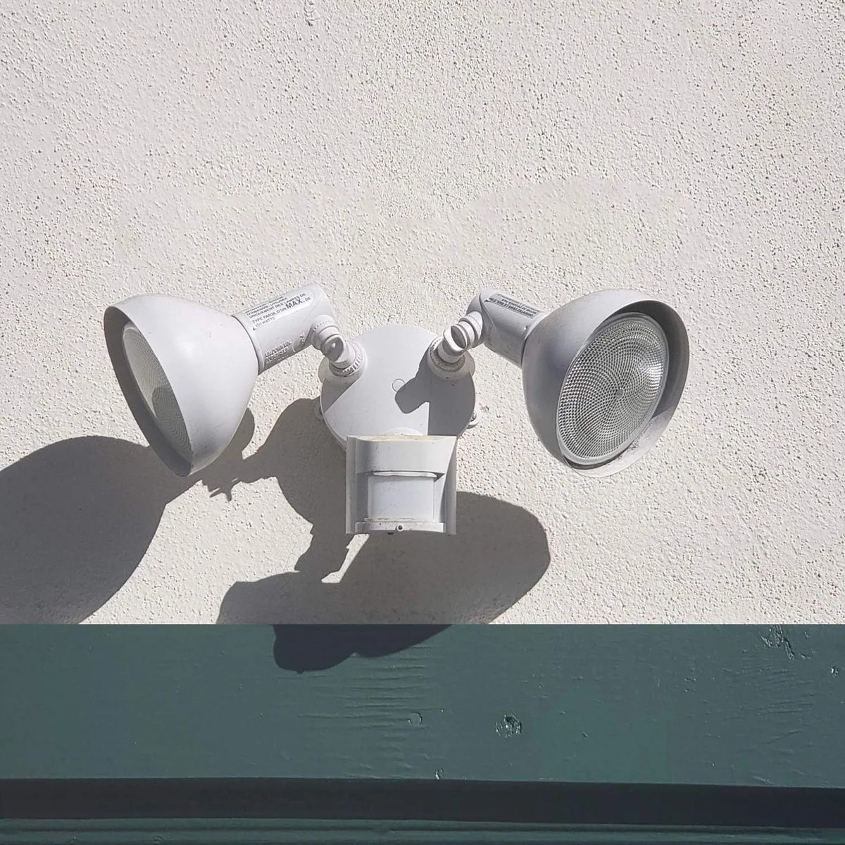 A two-head security floodlight fitted with PAR38 bulbs
